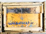 a picture of a wooden box with graffiti on it