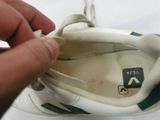 a person tying a shoe with a string on it