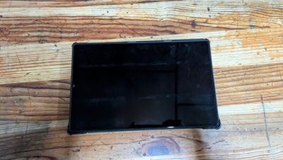 a small black object on a wooden table