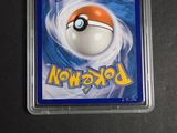 pokemon trading card in plastic case on black surface