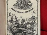 un vieux livre posé sur un canapé rouge, à côté d'un fauteuil rouge