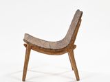 the chair is made of wood and has a woven seat