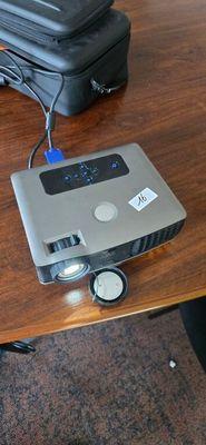 a small projector sitting on top of a wooden table