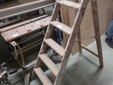 a man that is standing next to a ladder