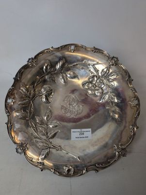 a silver plate with flowers and leaves on it