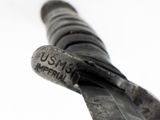 a close up of a metal object with a name on it