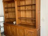 a large wooden bookcase in the corner of a living room