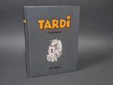 the book is on a gray surface with a black background