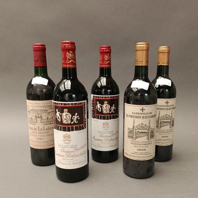 four bottles of wine are lined up in a row on a gray surface