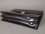 a black purse sitting on top of a table