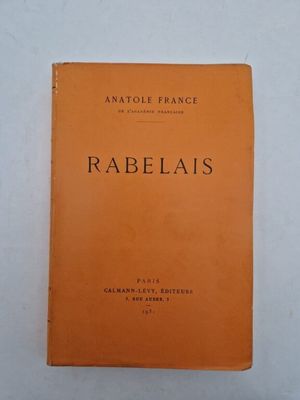 an orange book with black writing on it sitting on a white surface