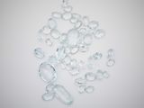 several pieces of clear glass sitting on top of a white surface