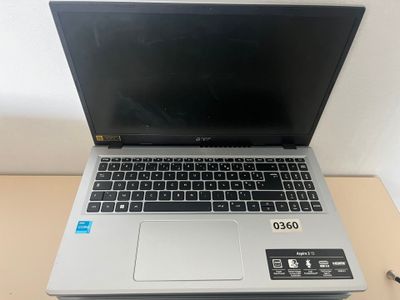 an open laptop computer sitting on top of a wooden desk