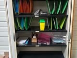 a metal cabinet with many files and folders on it