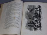 an open book on a table with a drawing on it