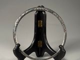 an image of a silver and black clock on a stand