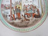 a plate with a picture of a group of people and a dog on it