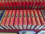 a lot of books that are sitting on a shelf