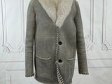 an image of a coat with a fur collar on a mannequin stand