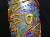 a vase that has a lot of different colored designs on it