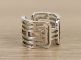 a silver ring with a square design on it