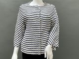 a mannequin wearing a black and white top and black pants