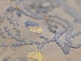 a close up of a piece of embroidery on a table