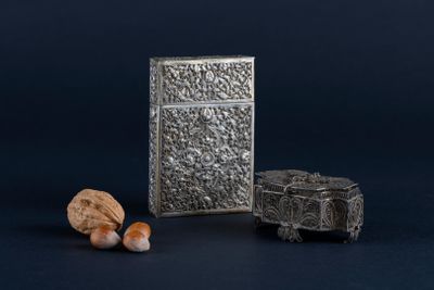 an old silver box and a rock on a blue background