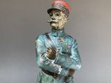 statue of a man in uniform with a pipe in his mouth