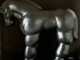 a statue of a horse standing on a marble base
