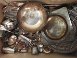 a box full of old silverware and other kitchen utensils