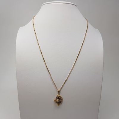 a gold plated necklace with a small elephant head on a gold chain