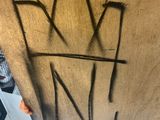 someone is writing on a piece of wood with a crown on it