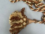 a brown and white rope with a knot on it