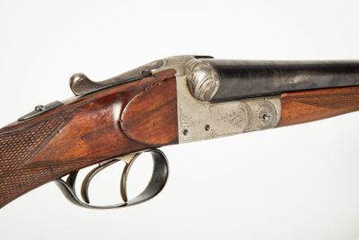 a close up of a rifle with a gun on it ' s side