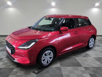 une voiture rouge est garée sur le sol en damier d'un garage