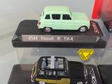 three toy cars on display in a display case