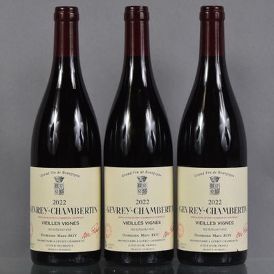 three bottles of wine are lined up on a table