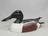 an image of a wooden duck sitting on top of a white surface