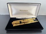 two pens sitting in a black box on a table