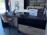 a desk with a laptop and a chair in a room