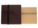 a close up of a brown and tan book with a black ribbon