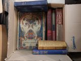 many books in a cardboard box on the table