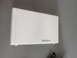 a white air conditioner on the wall next to a cup of coffee