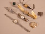 many different types of watches and bracelets on the table