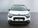 the front view of a white citrole parked in a white room