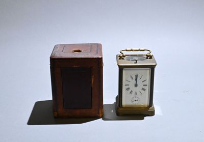 two small clocks sitting next to each other on a table