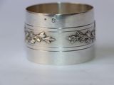 a close up of a silver ring on a white surface