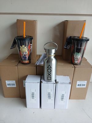 several boxes and cups are stacked on top of each other on a table