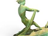 statue of a boy with a green cloth on a base